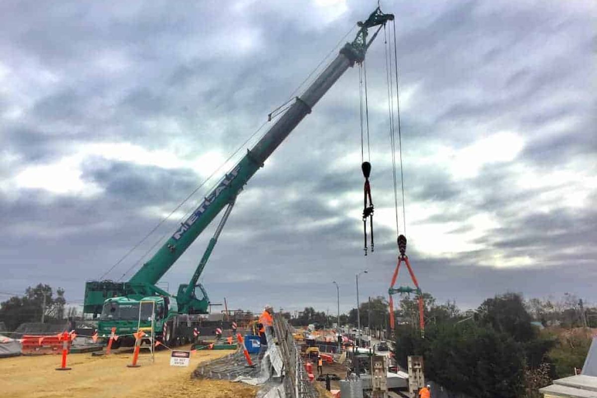 Australian rental company Metcalf Crane Services utilized the integrated heavy-duty jib, (known locally as a ‘machinery runner’), on a Grove GMK5250L to handle the delicate unloading and installation of wall panels for a new rail corridor project in Seaford, Victoria. Using the machinery runner from the Grove all-terrain crane, which is integrated into the crane’s swingaway jib, allows the use of both main and auxiliary hoists for the operation of two hooks simultaneously. The design of the machinery runner provides greater distance between the two hooks, making it perfect for applications such as panel installations.